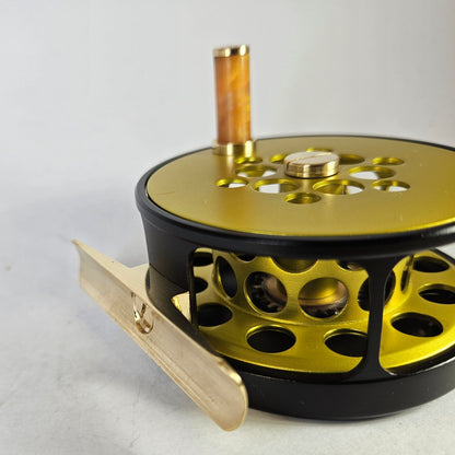 #4 Black and yellow full cage fly reel.